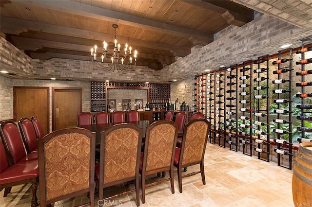 wine room with wood ceiling, beamed ceiling, brick wall, and an inviting chandelier