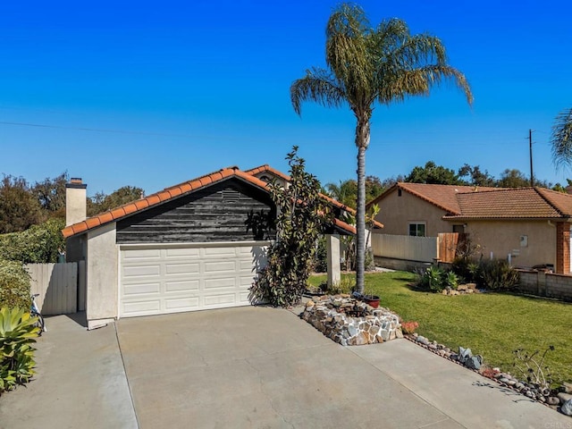 view of front of home with a chimney, stucco siding, a front yard, fence, and driveway