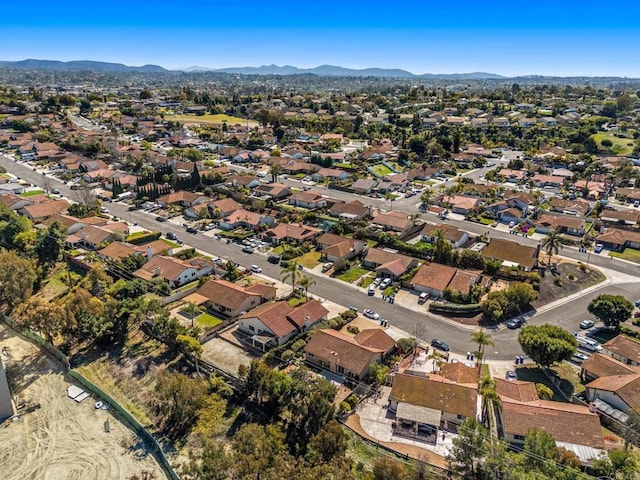 drone / aerial view featuring a residential view and a mountain view