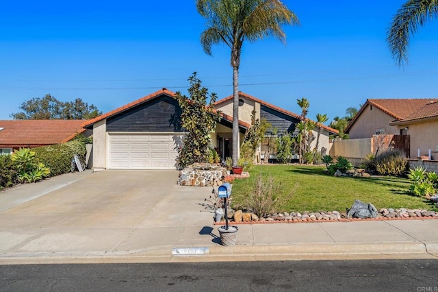 view of front of house featuring a garage, concrete driveway, and a front yard