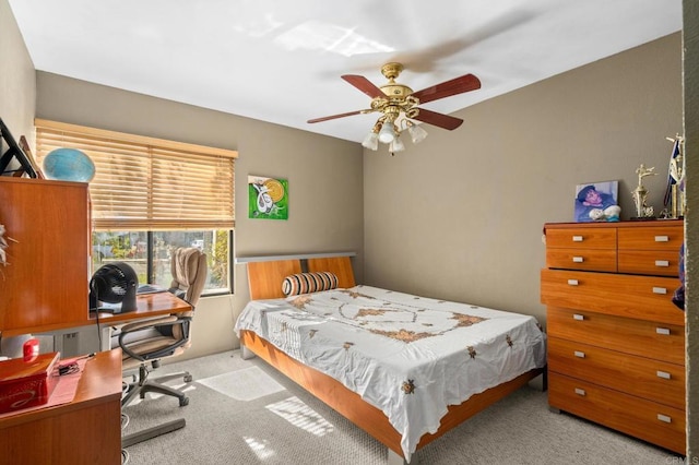 bedroom with a ceiling fan and light colored carpet