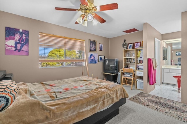 bedroom with ensuite bathroom and ceiling fan