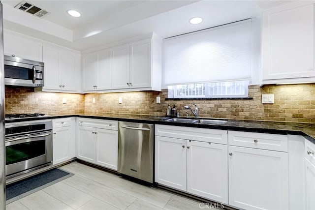 7249 Franklin Ave Unit 205, Hollywood Hills, CA 90046 - kitchen with appliances with stainless steel finishes, a sink, white cabinets, backsplash, and recessed lighting