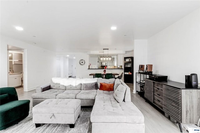 7249 Franklin Ave Unit 205, Hollywood Hills, CA 90046 - living area featuring light wood-style flooring, recessed lighting, and baseboards