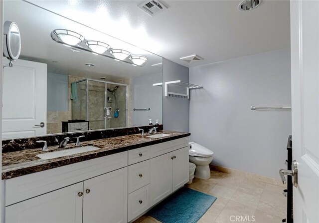 7249 Franklin Ave Unit 205, Hollywood Hills, CA 90046 - full bathroom with a stall shower, double vanity, toilet, baseboards, and tile patterned flooring