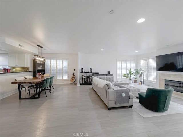 7249 Franklin Ave Unit 205, Hollywood Hills, CA 90046 - living area with healthy amount of natural light, recessed lighting, a fireplace, and baseboards