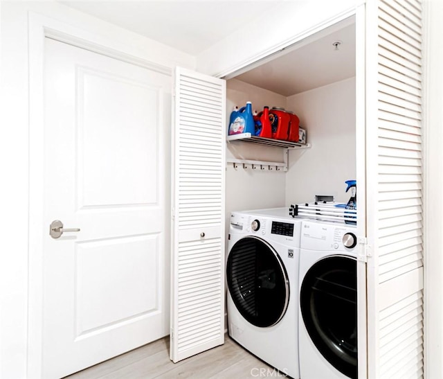 7249 Franklin Ave Unit 205, Hollywood Hills, CA 90046 - laundry room with washing machine and clothes dryer and light wood-type flooring