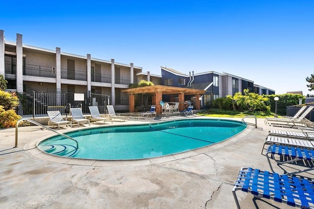 pool featuring a patio area and fence