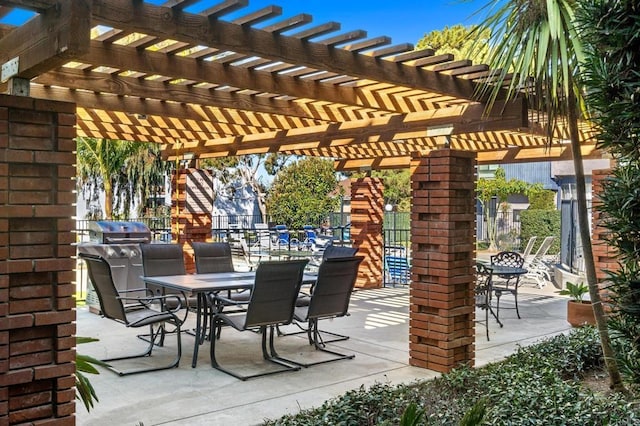 view of patio featuring outdoor dining space, area for grilling, and a pergola