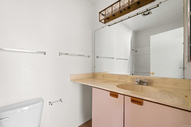 bathroom featuring toilet and vanity