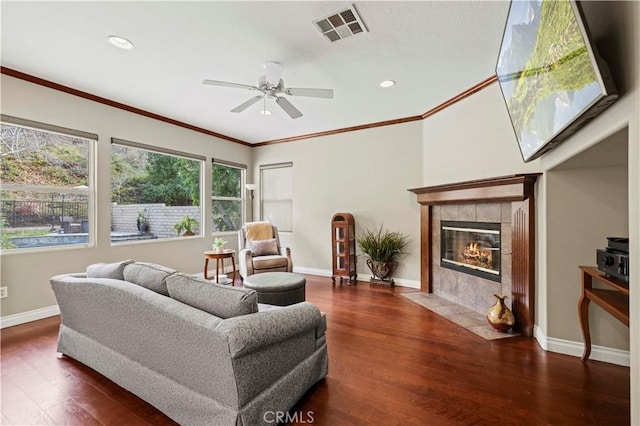 living room featuring visible vents, baseboards, and wood finished floors