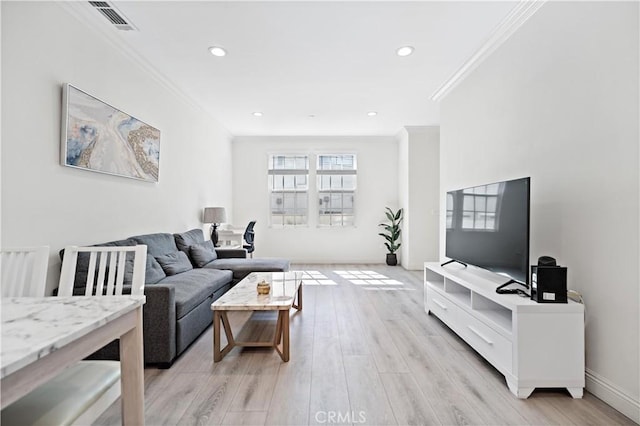 living area with recessed lighting, light wood-type flooring, visible vents, and crown molding