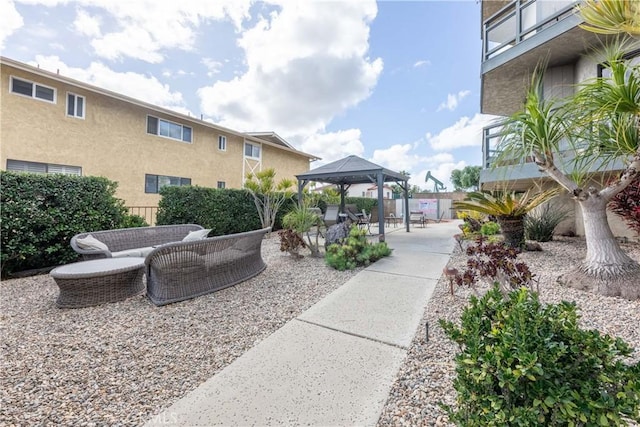 view of property's community with a patio area, fence, and a gazebo