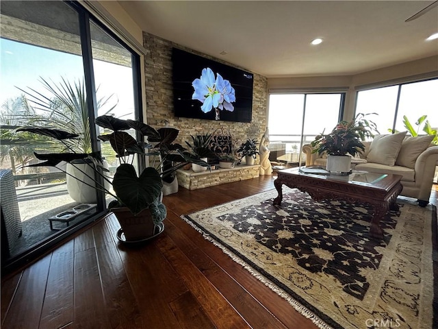 living area featuring a fireplace, hardwood / wood-style flooring, and recessed lighting