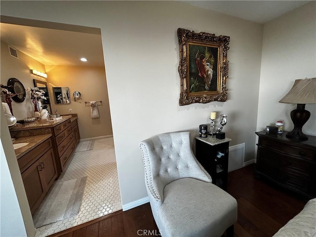 living area with dark wood-style flooring, visible vents, and baseboards