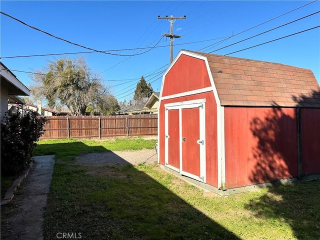 view of shed featuring fence