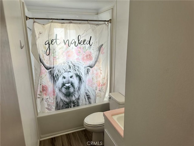 bathroom featuring wood finished floors, toilet, and shower / tub combo with curtain