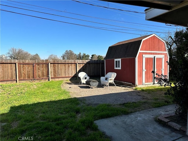 view of yard with an outbuilding, a storage unit, and fence