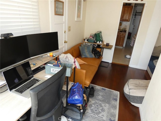 office featuring baseboards and dark wood finished floors