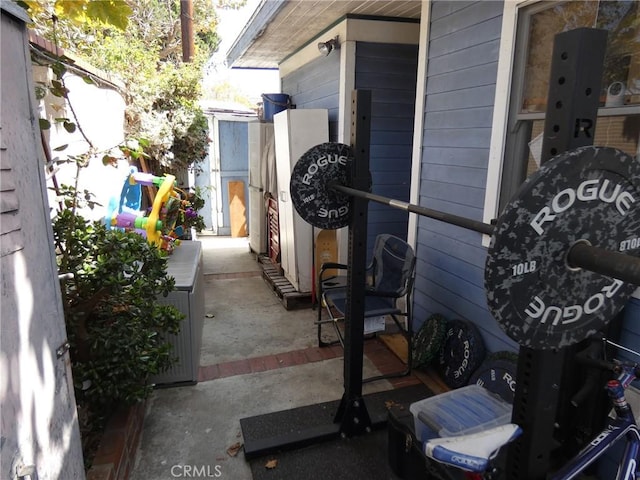 view of side of property with a patio area and fence