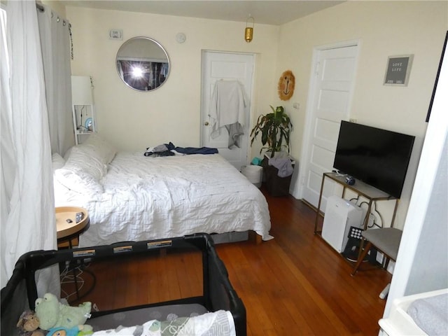 bedroom with dark wood finished floors