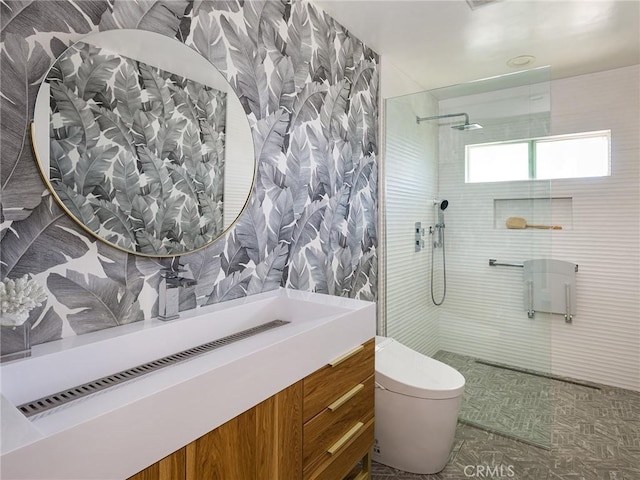 full bathroom featuring toilet, a walk in shower, and vanity