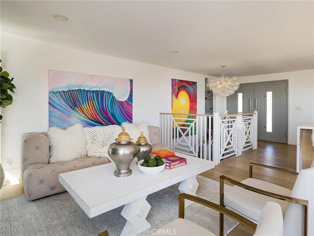 living area with a chandelier, recessed lighting, and wood finished floors