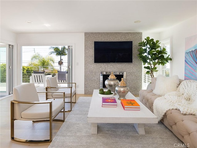 living area featuring light wood-style flooring, baseboards, and recessed lighting