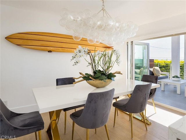 dining area featuring wood finished floors and baseboards