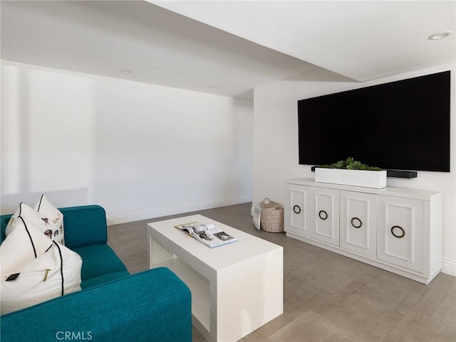 living area with baseboards and recessed lighting