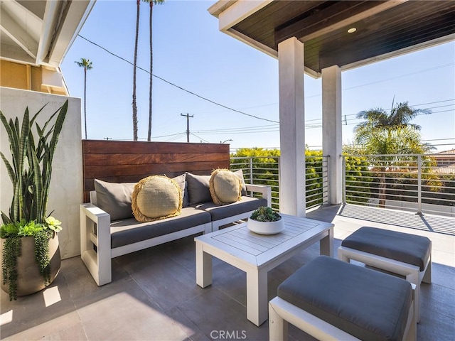 view of patio with an outdoor living space and a balcony