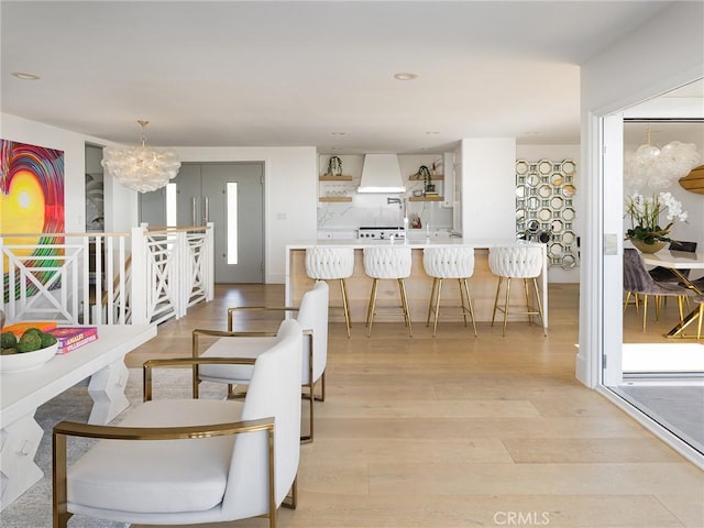 dining room with light wood-style floors, recessed lighting, and an inviting chandelier