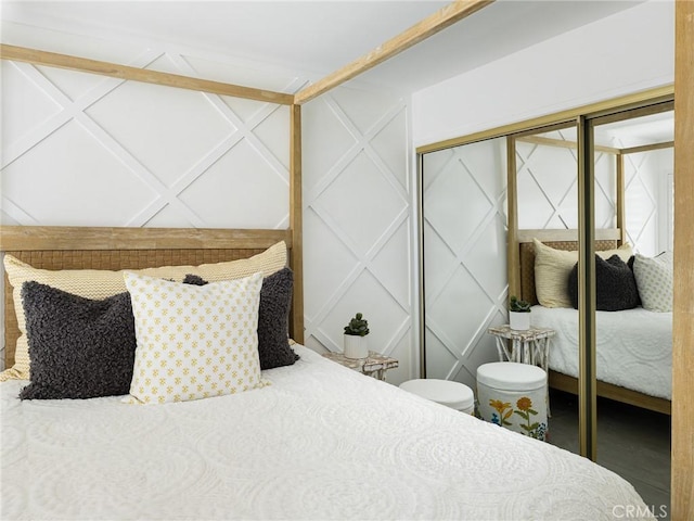 bedroom with a closet and a decorative wall