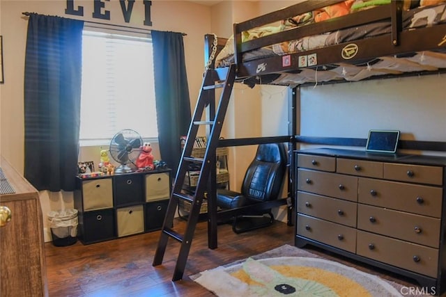 bedroom featuring dark wood-style flooring