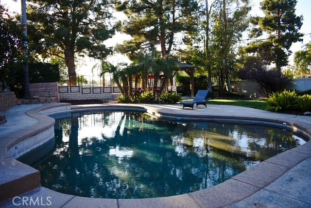 view of swimming pool with a gazebo, fence, and a fenced in pool