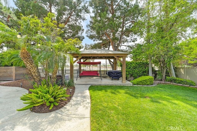 surrounding community featuring a lawn, a gazebo, a patio area, and a fenced backyard