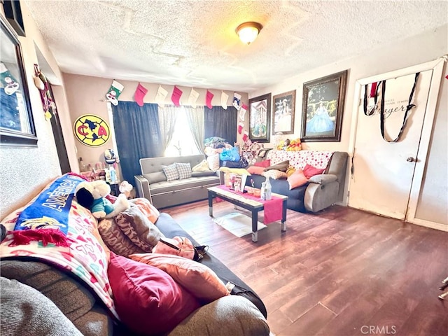 living area featuring a textured ceiling and wood finished floors