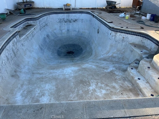 view of swimming pool with an empty pool