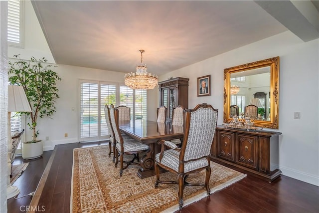 dining room with dark wood-style flooring, baseboards, and an inviting chandelier