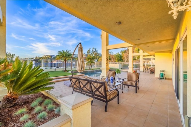 view of patio featuring a fenced backyard, an outdoor living space, and an outdoor pool