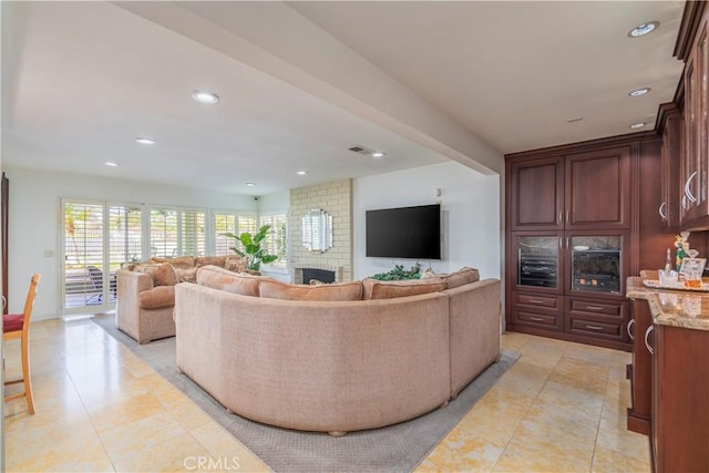 living room with a brick fireplace, light tile patterned floors, visible vents, and recessed lighting