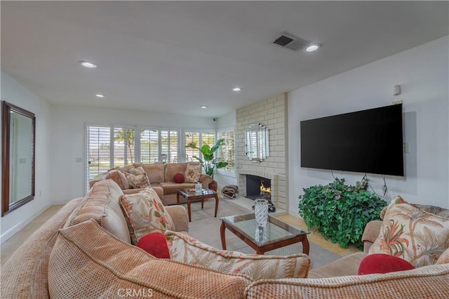 living area featuring recessed lighting, visible vents, a fireplace, and baseboards