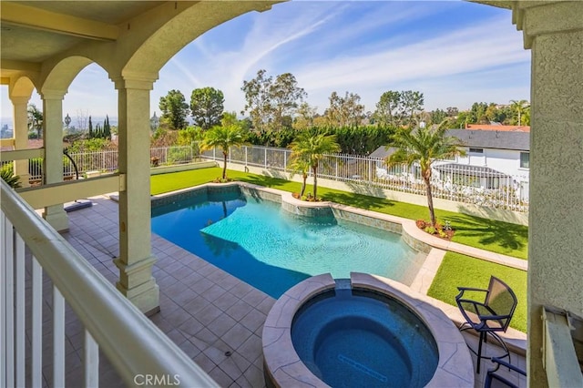 view of pool with a pool with connected hot tub, a fenced backyard, and a patio