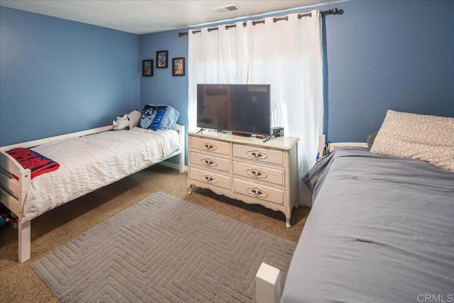 bedroom featuring light carpet and visible vents