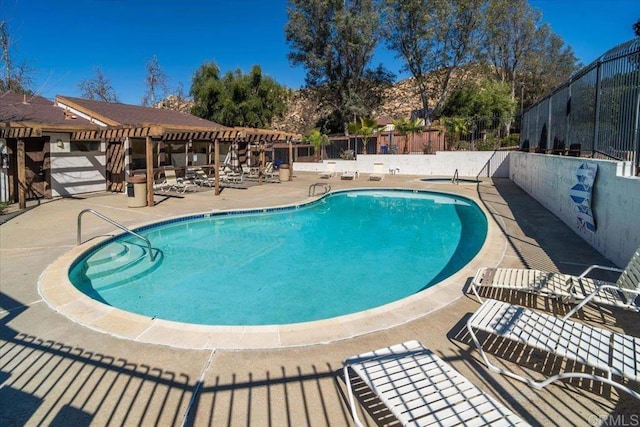 community pool featuring a patio area and fence