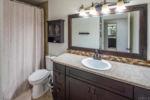 bathroom with toilet, backsplash, and vanity