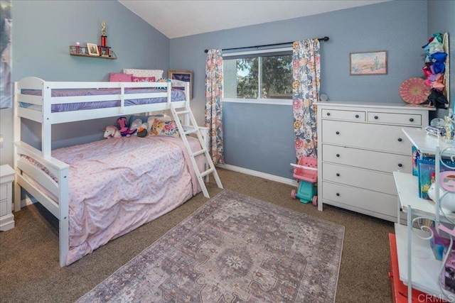 bedroom with lofted ceiling, baseboards, and dark colored carpet