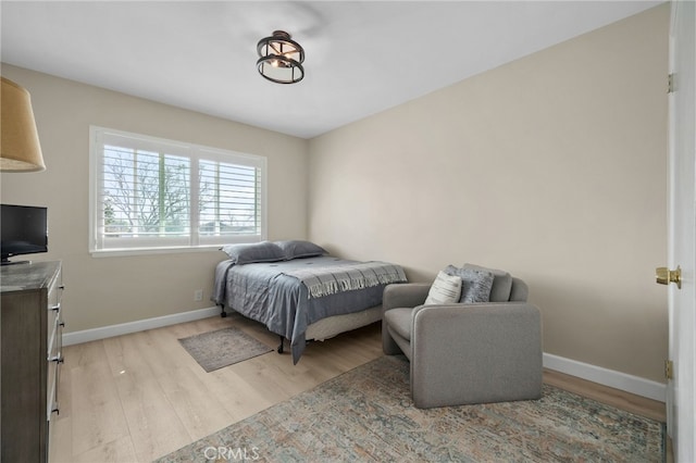 bedroom with light wood-type flooring and baseboards