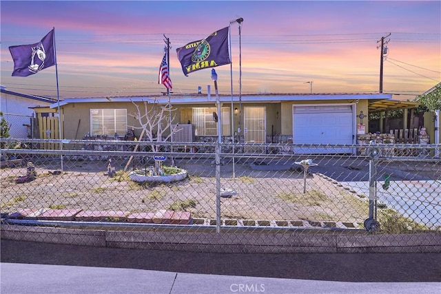 view of front of property featuring fence, an attached garage, and stucco siding