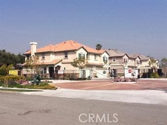 view of property with driveway and a residential view